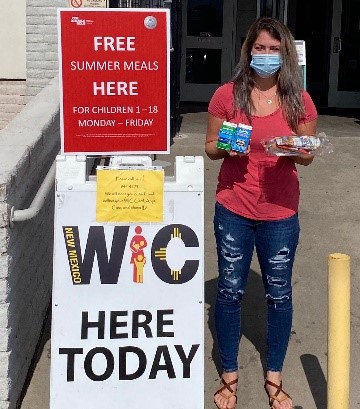 Pictured: New Mexico WIC staff member offering WIC service and free summer meals at WIC’s curbside clinic. 